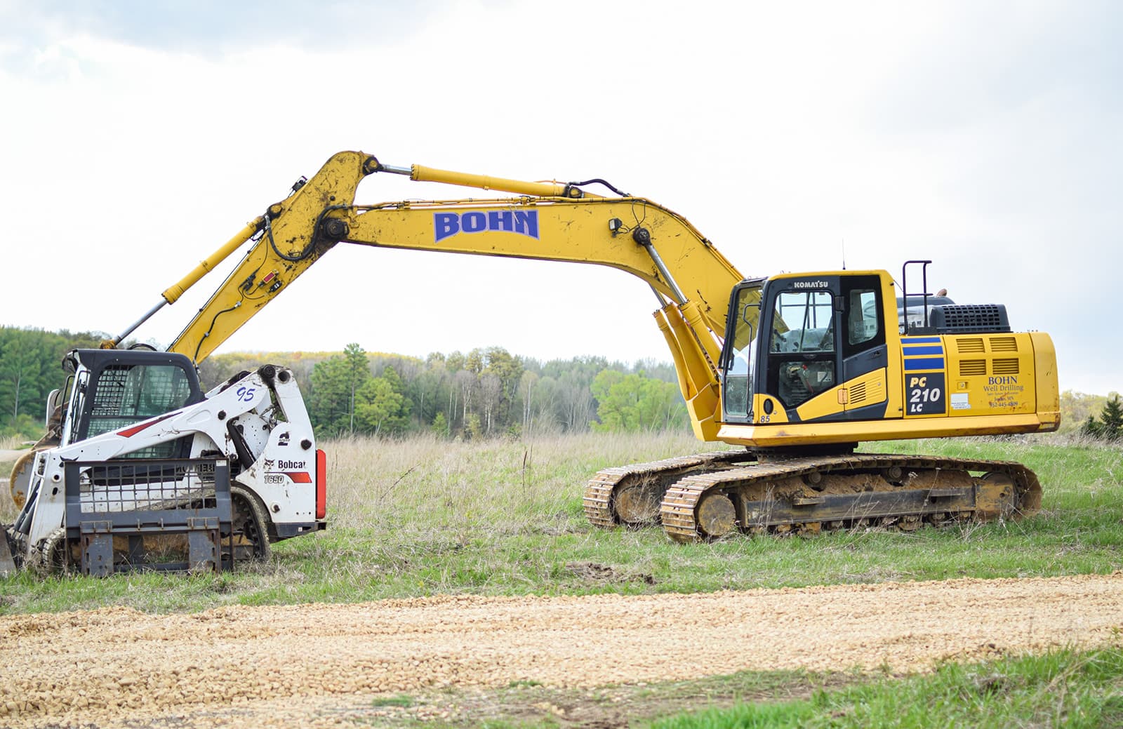 Excavator and Bobcat staged at the Oakridge lot.