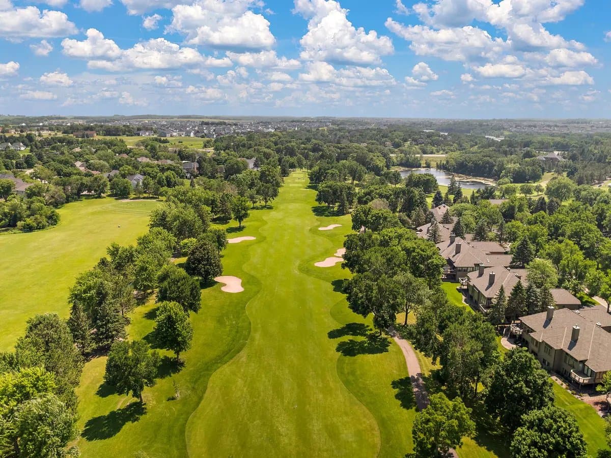 Aerial of a fairway at Prestwick Golf Club in Woodbury, homes lining the eastern edge.